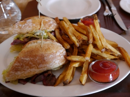 A flavorful pastrami sandwich enjoyed at the Frog's End Tavern, Glenmere Mansion