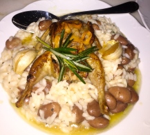 Roasted quail with garlic and rosemary served on a bed of mushroom and bean risotto. 